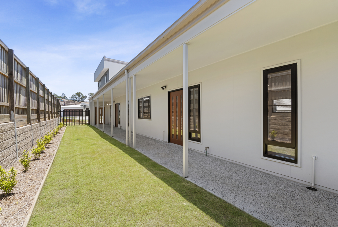 Side access — level exposed aggregate driveway, FAAC automated gate